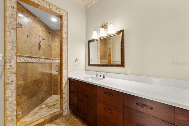 bathroom with a shower with door, vanity, tile patterned flooring, and ornamental molding