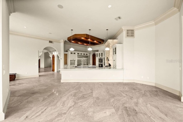 spare room featuring visible vents, baseboards, arched walkways, ornamental molding, and marble finish floor