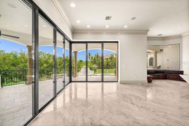 empty room with light tile patterned flooring and crown molding