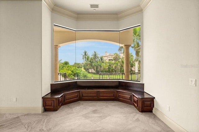 unfurnished room with visible vents, a healthy amount of sunlight, crown molding, and ornate columns