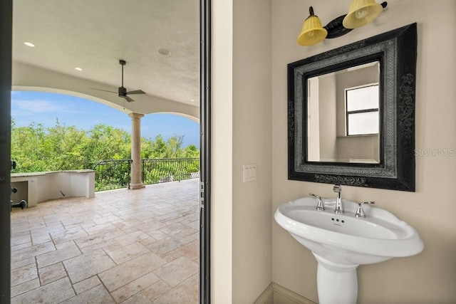 bathroom featuring stone tile floors, recessed lighting, and ceiling fan