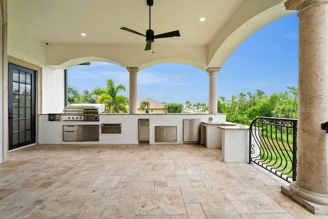 view of patio with area for grilling, ceiling fan, and exterior kitchen