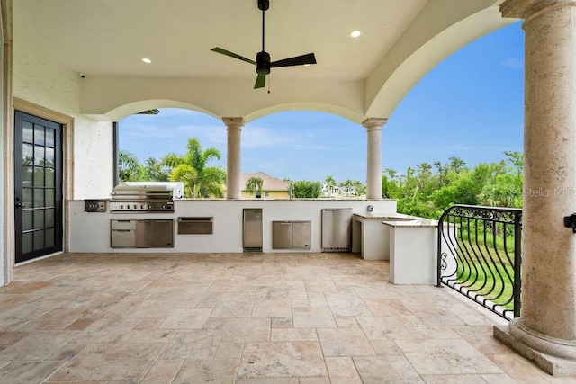 view of patio featuring ceiling fan, a balcony, area for grilling, and an outdoor kitchen