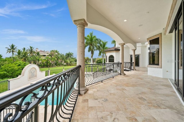 balcony featuring a fenced in pool