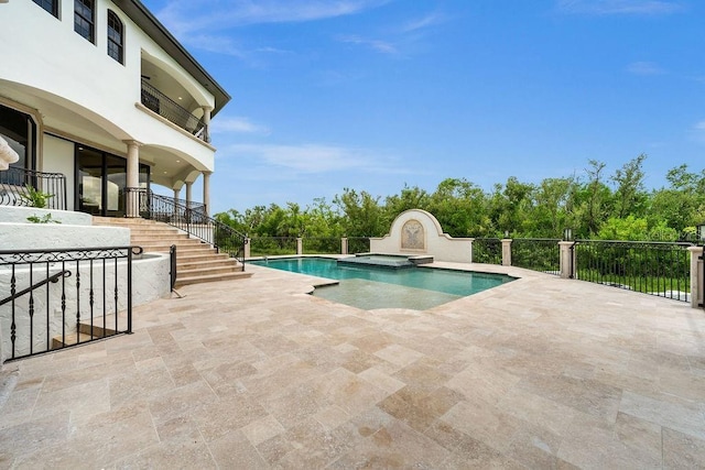 view of pool featuring a patio area, stairway, and a pool with connected hot tub