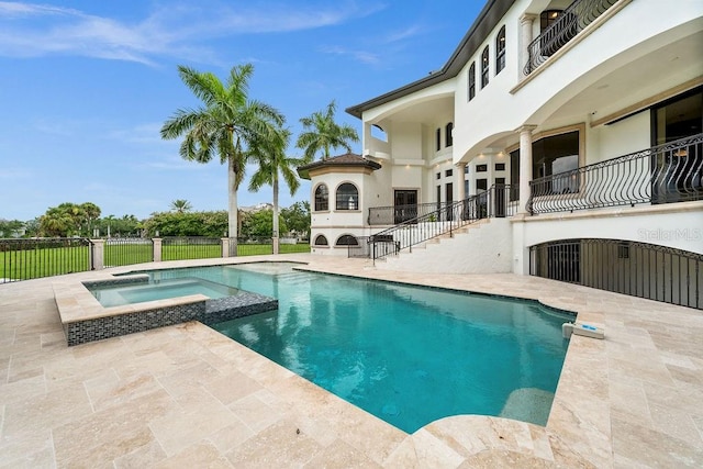 view of swimming pool featuring an in ground hot tub and a patio