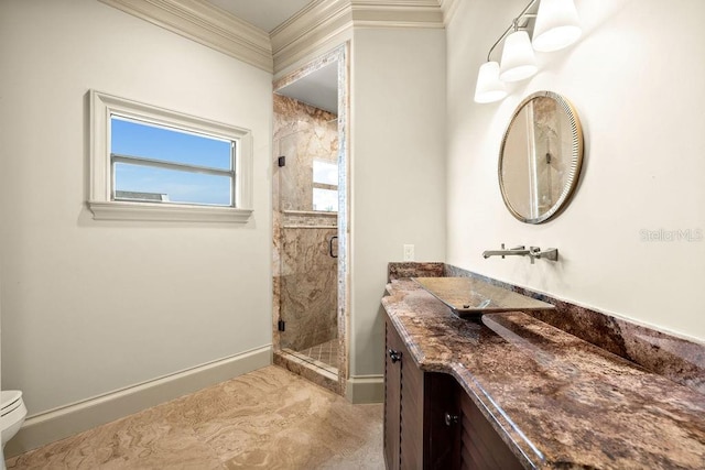 bathroom featuring a shower with shower door, vanity, crown molding, and toilet