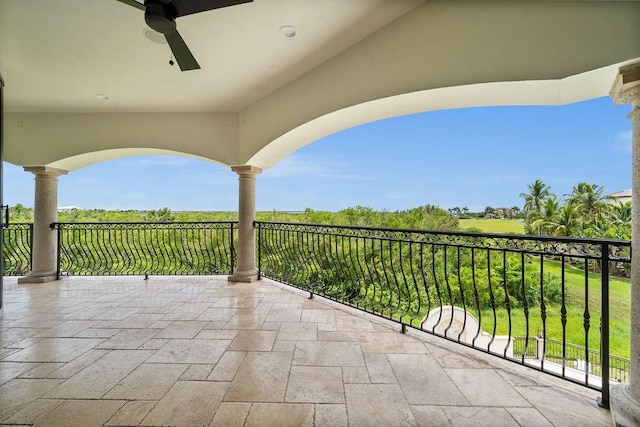 view of patio with a balcony and ceiling fan