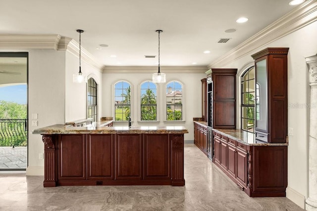 kitchen featuring light stone counters, visible vents, marble finish floor, and hanging light fixtures