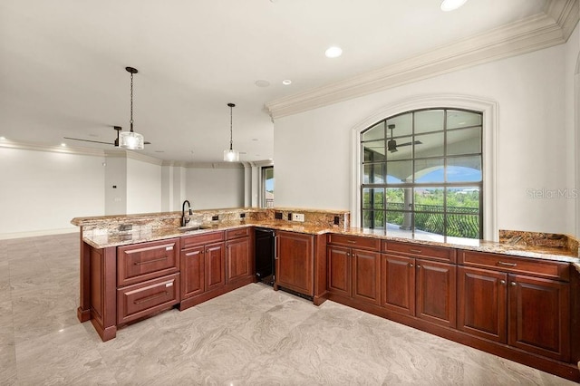 kitchen with light tile patterned flooring, kitchen peninsula, light stone counters, decorative light fixtures, and sink