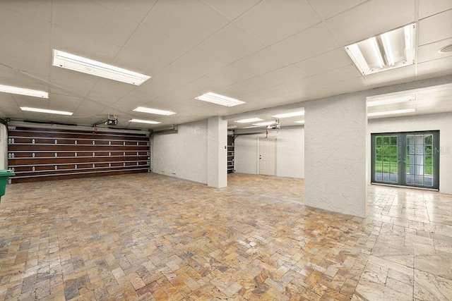 garage with a garage door opener and a textured wall