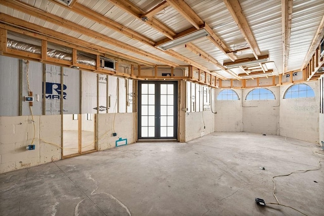 miscellaneous room featuring concrete flooring and french doors