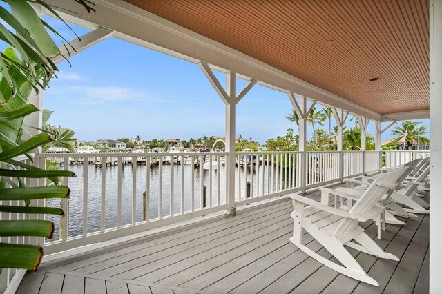 wooden terrace featuring a water view