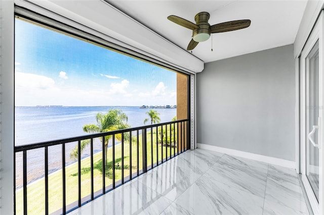 balcony featuring ceiling fan and a water view