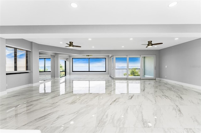 unfurnished living room with ceiling fan