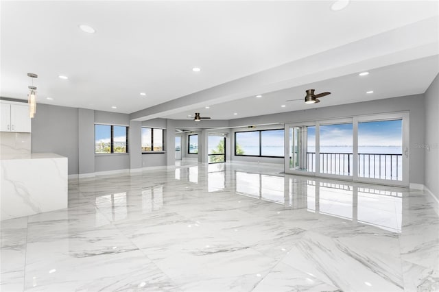 unfurnished living room featuring ceiling fan