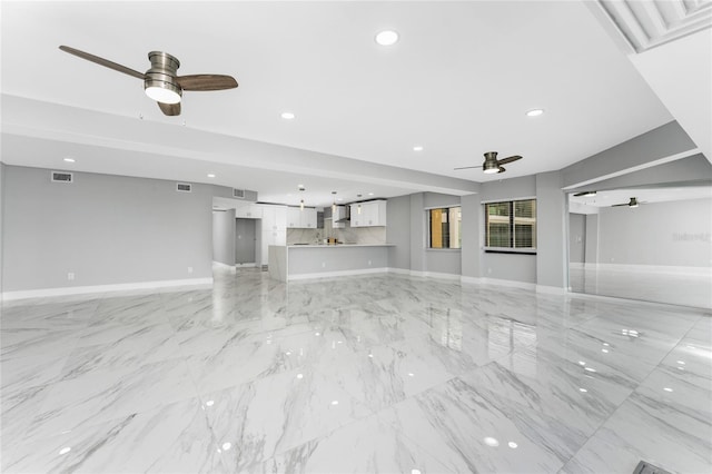 unfurnished living room with ceiling fan