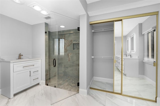 bathroom featuring vanity and an enclosed shower