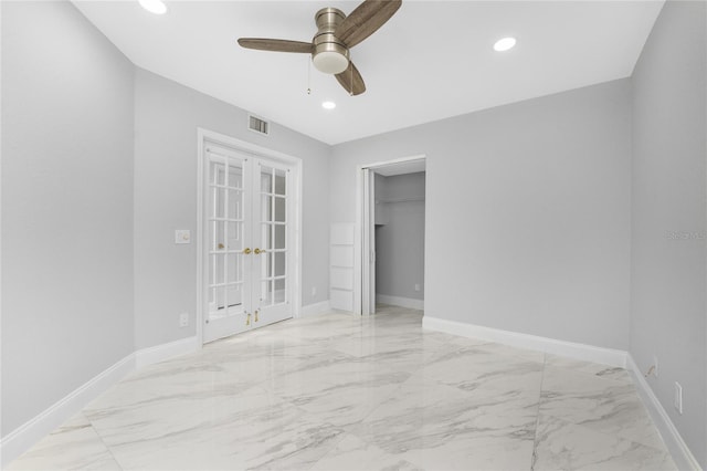 unfurnished room with ceiling fan and french doors