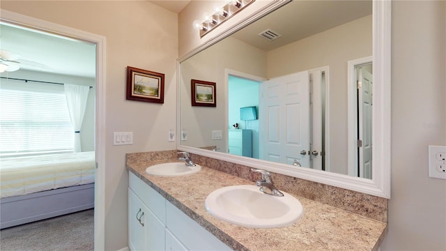 bathroom with ceiling fan and double vanity