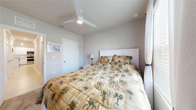 tiled bedroom featuring a closet and ceiling fan