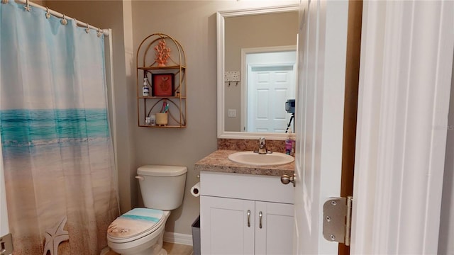 bathroom featuring toilet and vanity