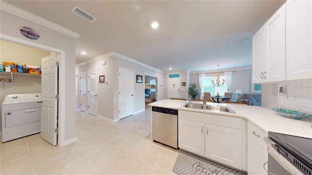 kitchen with stainless steel appliances, washer / clothes dryer, visible vents, a sink, and a peninsula