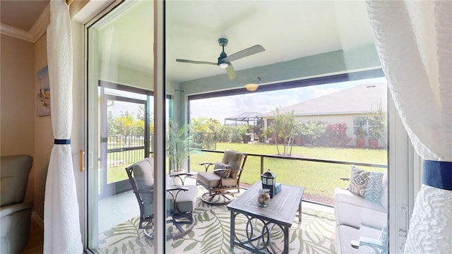 sunroom featuring ceiling fan