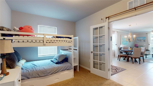 bedroom with a chandelier, multiple windows, light tile patterned flooring, and visible vents