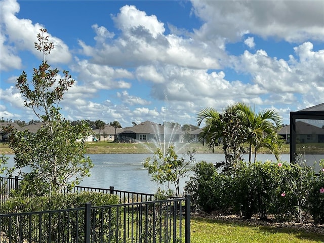 property view of water featuring fence