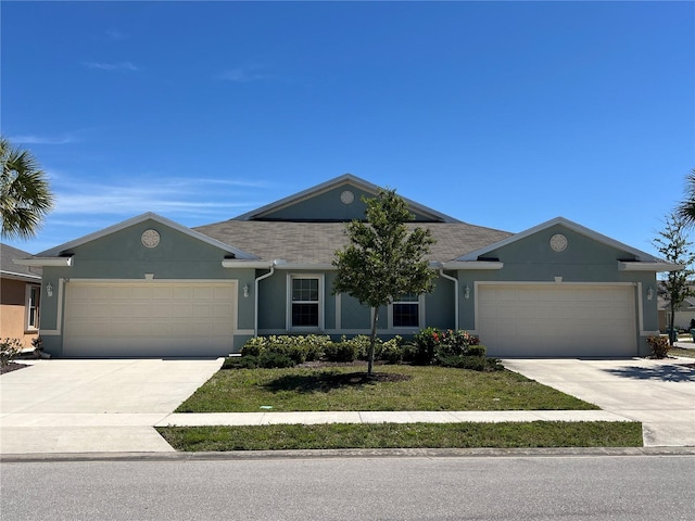 single story home featuring stucco siding, driveway, and a garage