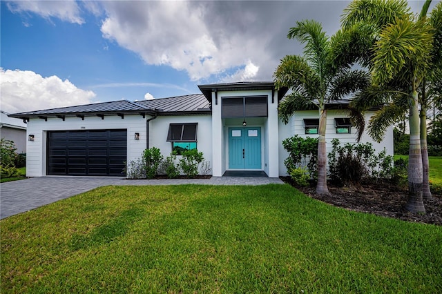 view of front of property with a front lawn and a garage