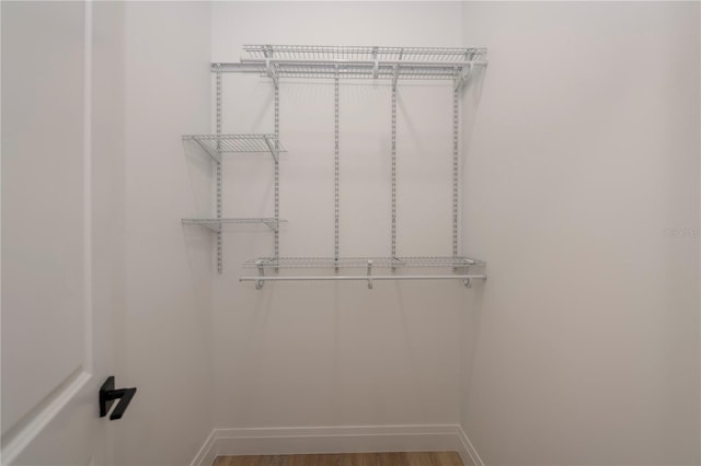 spacious closet featuring hardwood / wood-style flooring