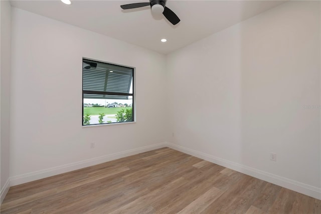 empty room with ceiling fan and light hardwood / wood-style floors