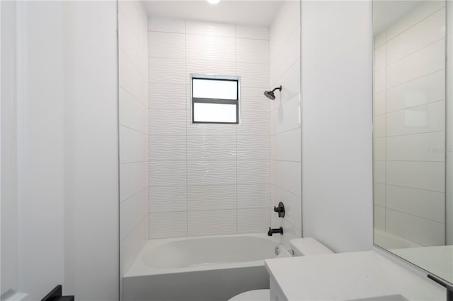 full bathroom with toilet, tiled shower / bath, and vanity