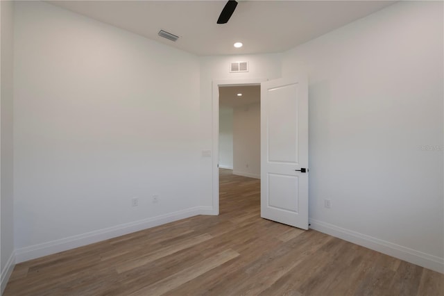 unfurnished room with ceiling fan and light wood-type flooring