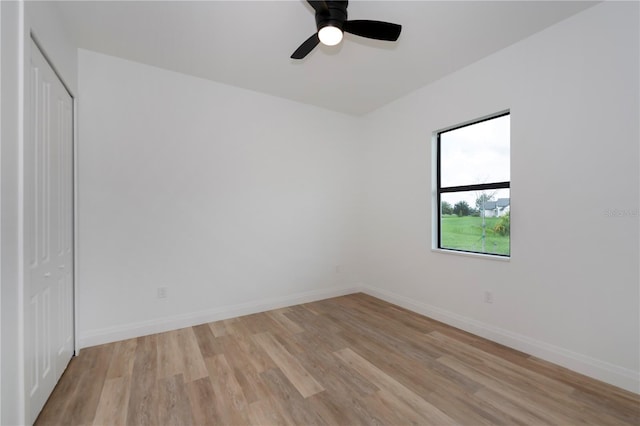 spare room with light hardwood / wood-style floors and ceiling fan