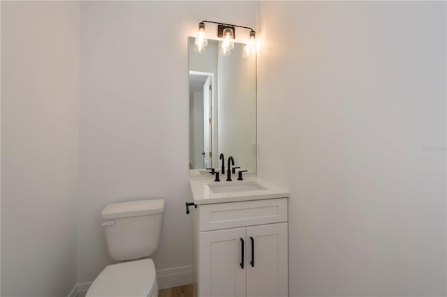 bathroom with toilet and vanity