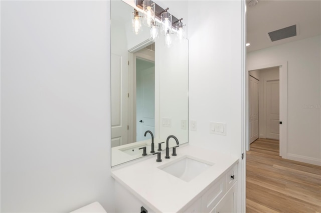 bathroom featuring hardwood / wood-style flooring and vanity