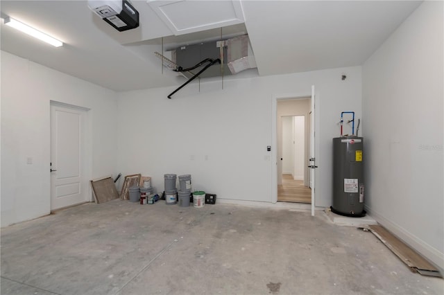 garage with a garage door opener and electric water heater