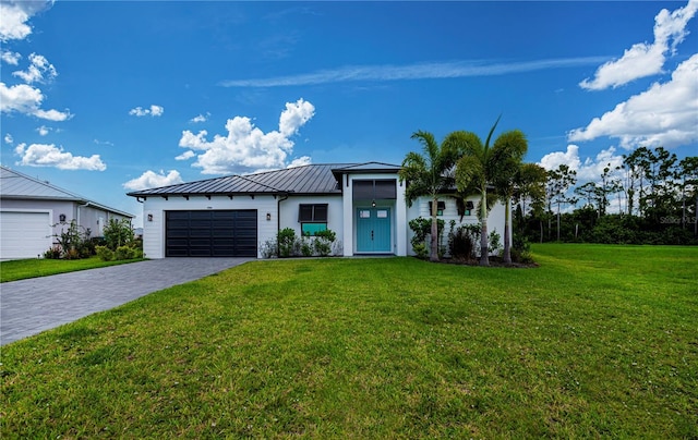 view of front facade with a front yard and a garage