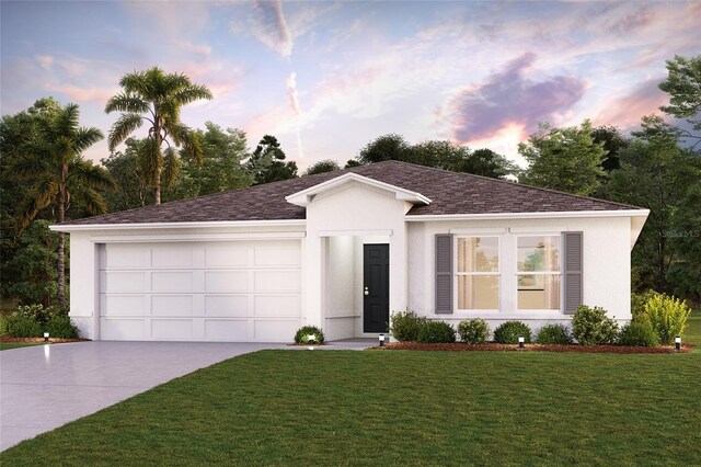 view of front facade with a garage and a yard