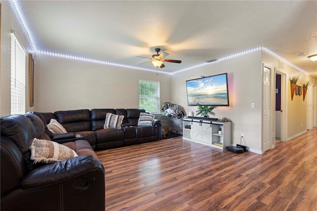 living room featuring crown molding, ceiling fan, and wood-type flooring