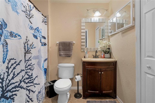 bathroom featuring vanity, tile patterned flooring, and toilet