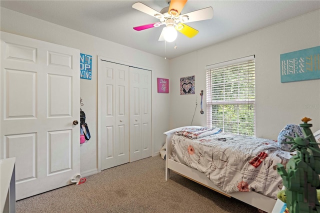 bedroom with baseboards, carpet flooring, a closet, and ceiling fan