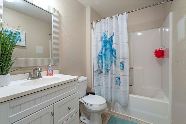 full bathroom with tile patterned floors, toilet, shower / tub combo, a textured wall, and vanity