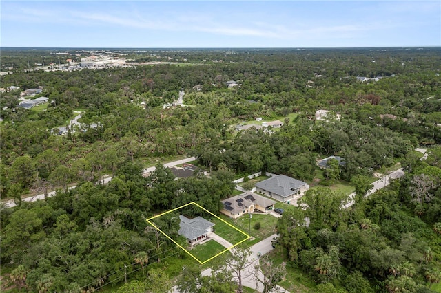 birds eye view of property with a view of trees