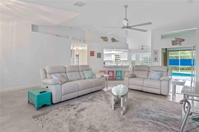 tiled living room featuring ceiling fan and lofted ceiling