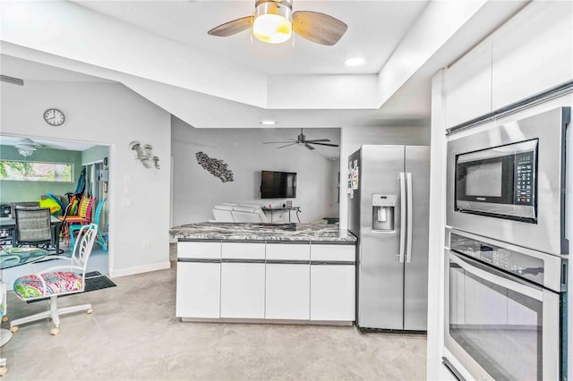 kitchen with appliances with stainless steel finishes, stone counters, and white cabinetry