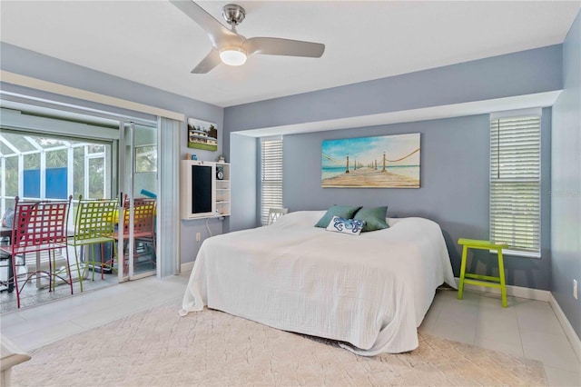 tiled bedroom with ceiling fan and access to exterior